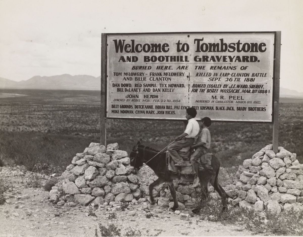 Sign entering Tombstone, Arizona mentioning the so-called Gunfight at the O.K. Corral, 1937. New York Public Library. Public Domain.