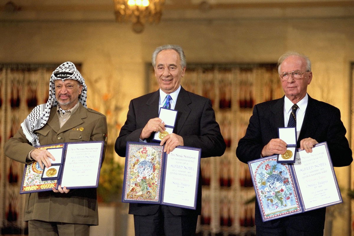 PLO Chairman Yasser Arafat, Israeli foreign minister Shimon Peres, and Israeli prime minister Yitzhak Rabin receive the Nobel Peace Prize, Saar Yaacov, 1994. Government Press Office (CC SA 3.0). PLO Chairman Yasser Arafat, Israeli foreign minister Shimon Peres, and Israeli prime minister Yitzhak Rabin receive the Nobel Peace Prize, Saar Yaacov, 1994. Government Press Office (CC SA 3.0).