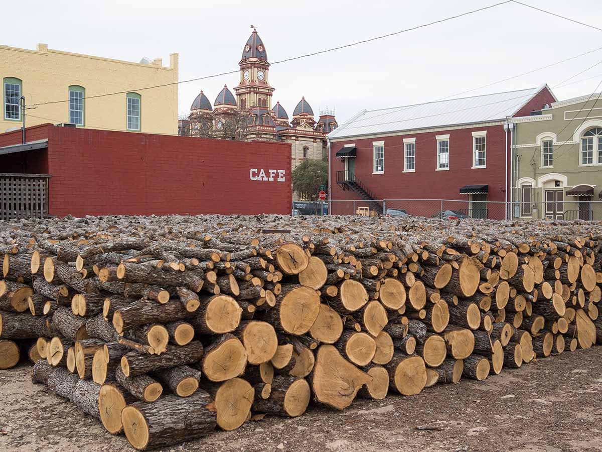 Firewood stacked outside Smitty’s Market, Lockhart, 2012. Alamy.