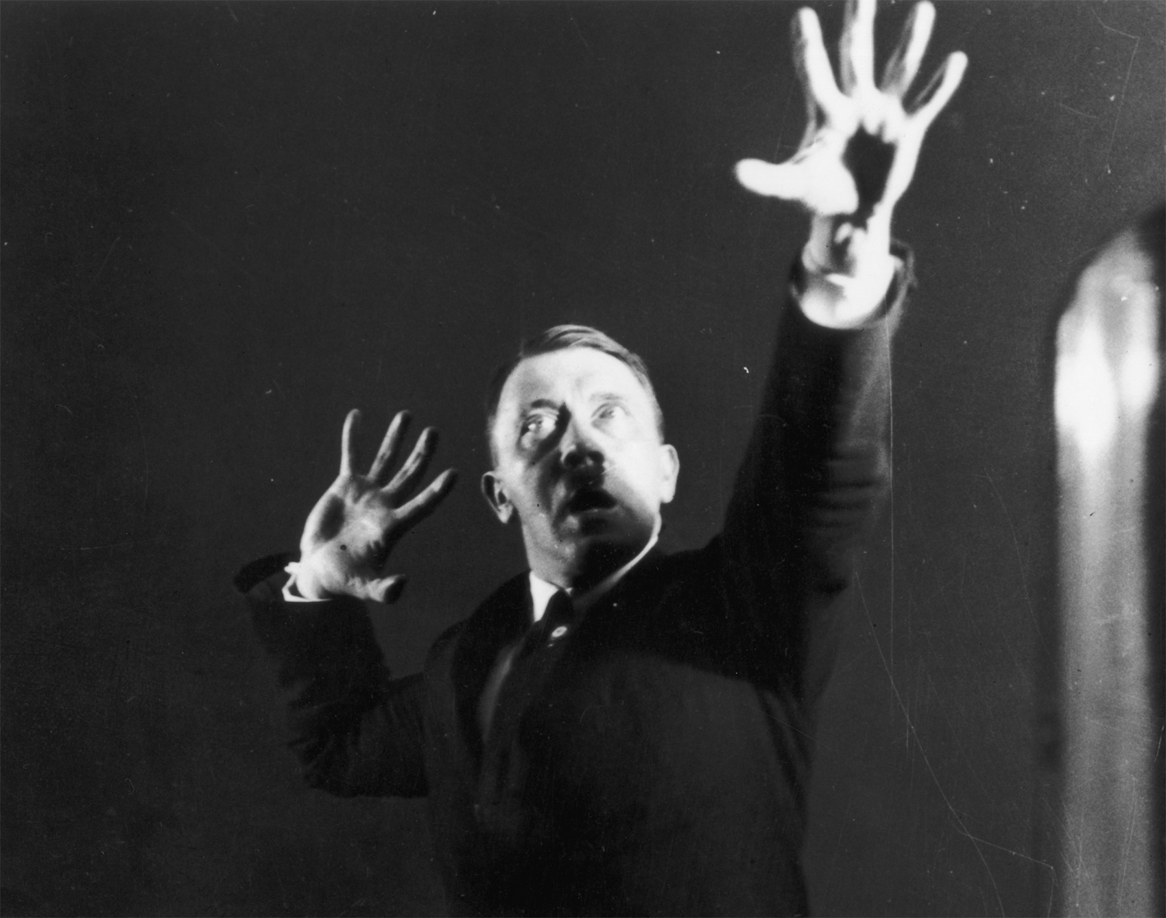 Hitler miming gestures to a record of his speeches; part of a series of photographs he commissioned in 1925 to aid self-analysis and improve his hold over an audience.