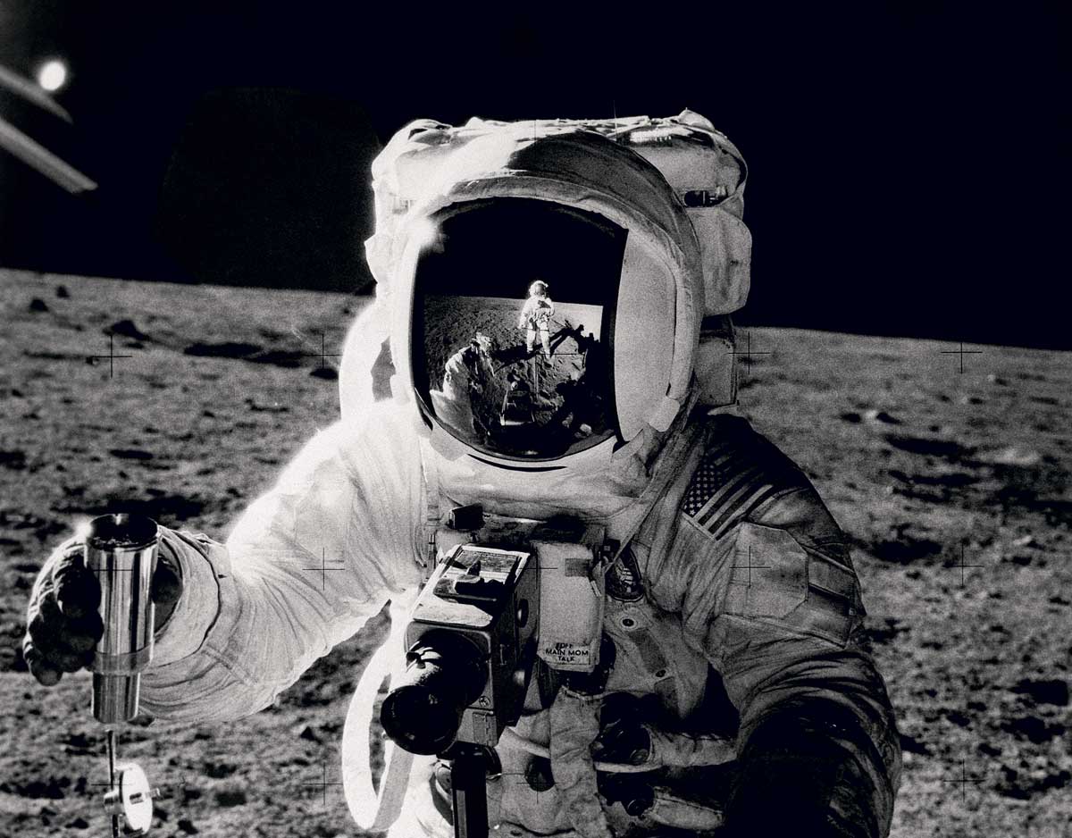 Alan Bean collecting soil samples, with Pete Conrad reflected in his visor, the Moon, November 1969 © Bettmann/Getty Images.