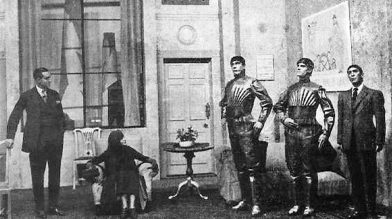 A scene from Karel Čapek's 1920 play R.U.R. (Rossum's Universal Robots), showing three robots.