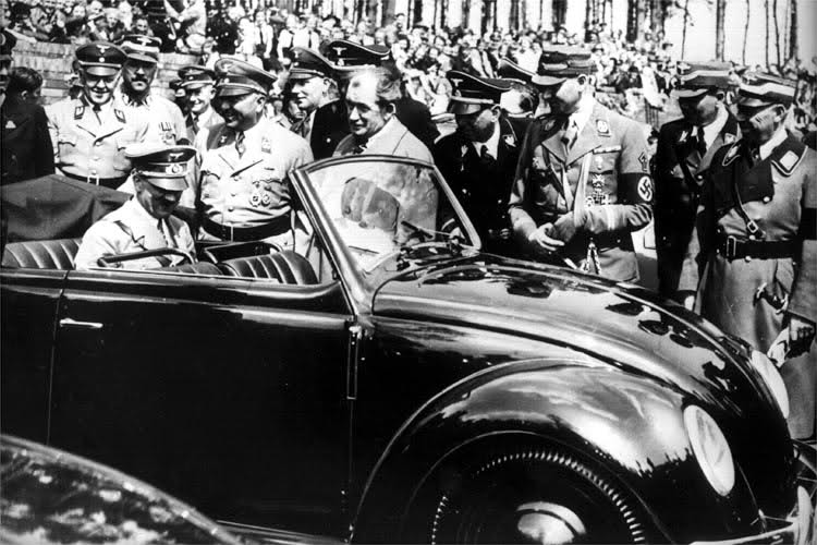 Hitler inside an early VW Beetle.