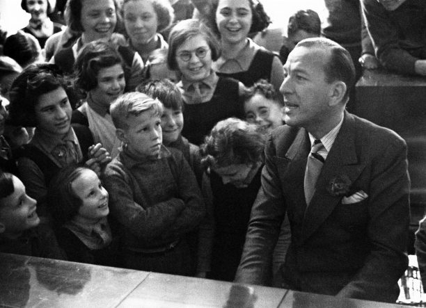 Coward visiting the Actors Orphanage, Chertsey, Surrey, where he was president, 1939. He arranged for all the children to be evacuated to New York the following year for the remainder of the war.