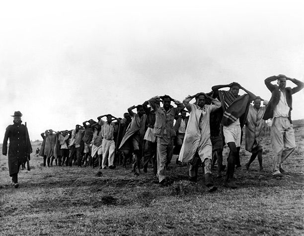 Mau Mau suspects led away for questioning by the police in Nairobi, Kenya, 1952.