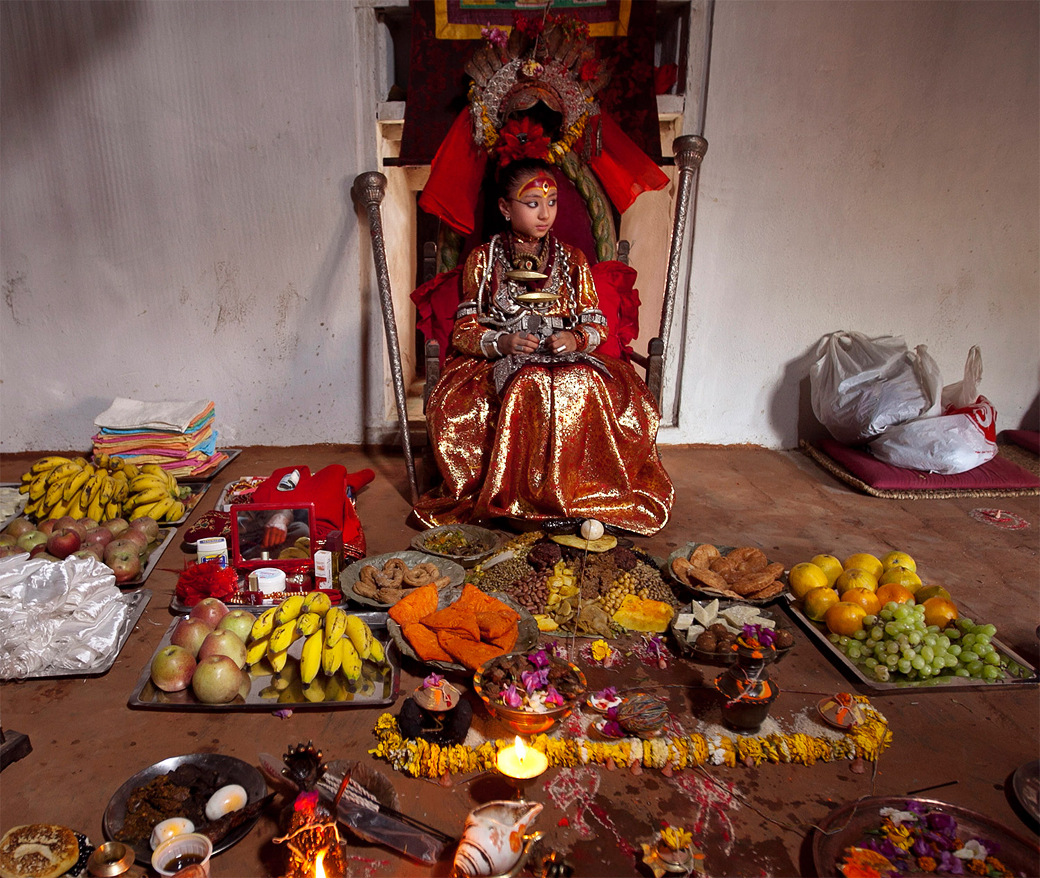 The Kumari Samita Bajracharya with offerings from worshippers, Patan, Nepal, 2011. Narendra Shrestha / EPA / Corbis Images