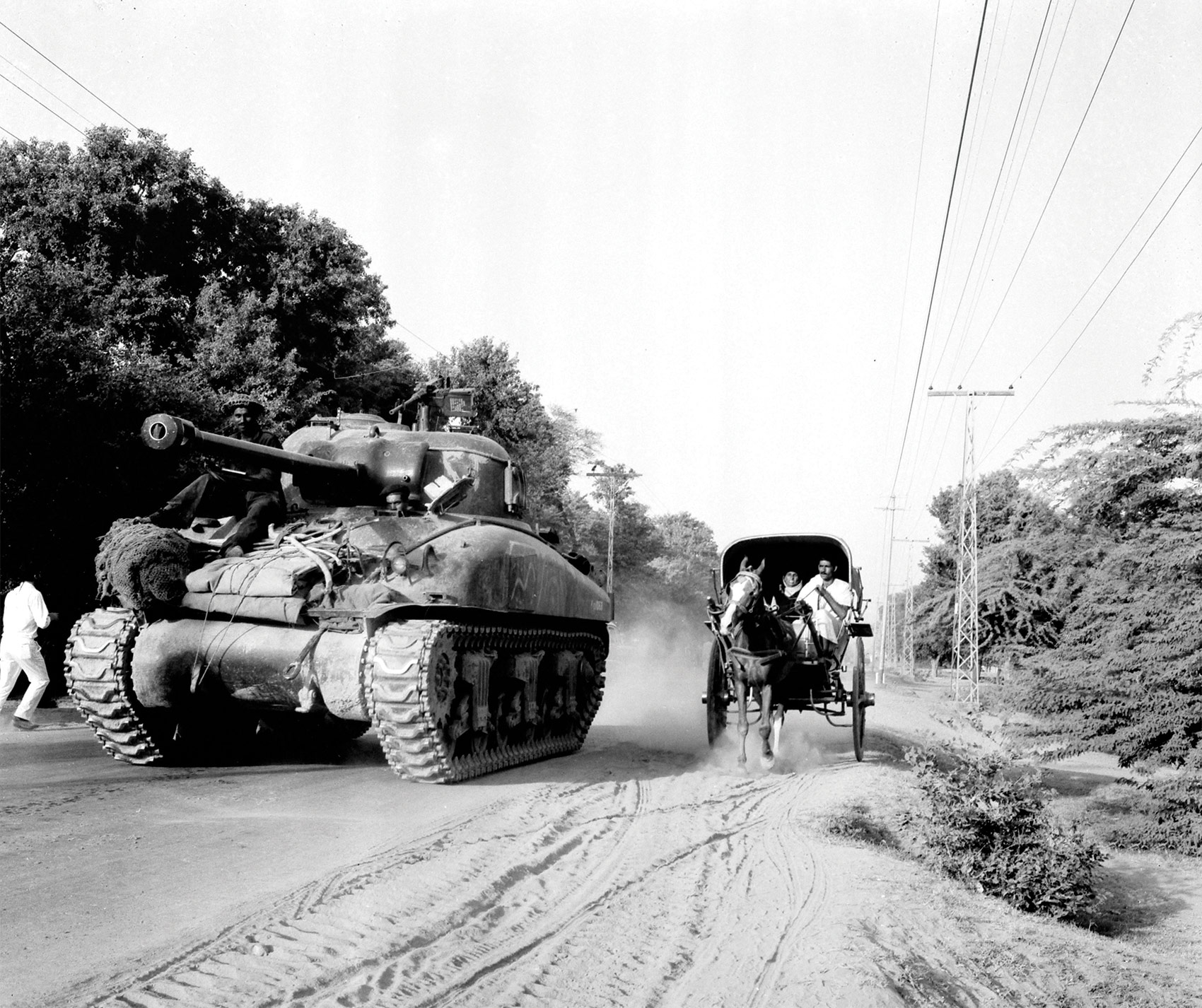 A US-built Sherman tank of the Pakistani army rumbles through Slalkot in the Pakistani Punjab in September 1965.