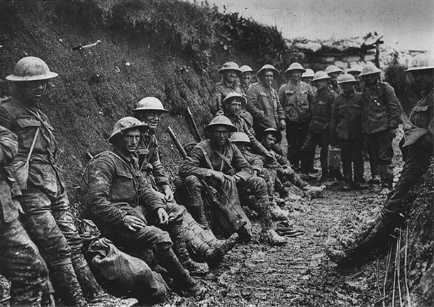 The Royal Irish Rifles, resting during the Battle of the Somme. The BBC extracted the seated soldier, second from left, and made him the end image of The Great War title sequence; he became a celebrity, with many viewers claiming he was their father. 