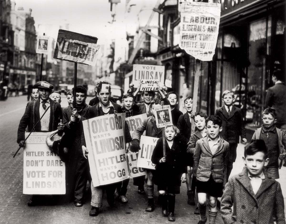 ‘Hitler wants Hogg’: children with placards supporting A.D. Lindsay, Oxford, 27 October 1938.