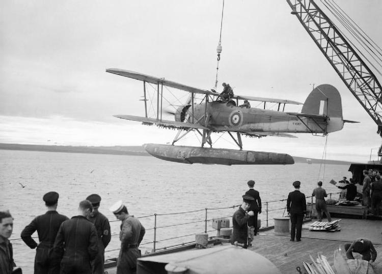 A Swordfish floatplane is hoisted aboard the battleship HMS Malaya in October 1941.
