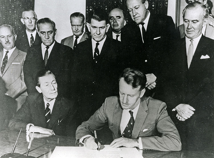 Ian Smith, prime minister of Rhodesia, signs his country's Unilateral Declaration of Independence, November 11th, 1965.