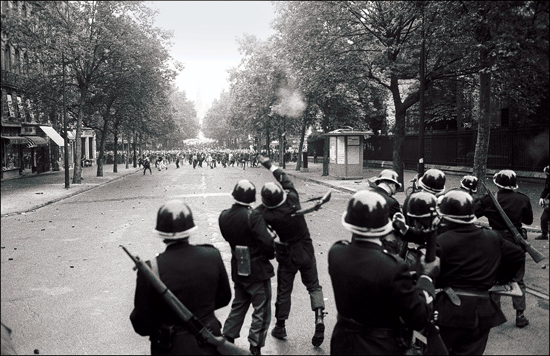 Revolting: members of the CRS throw grenades during student riots in Paris, 1968.