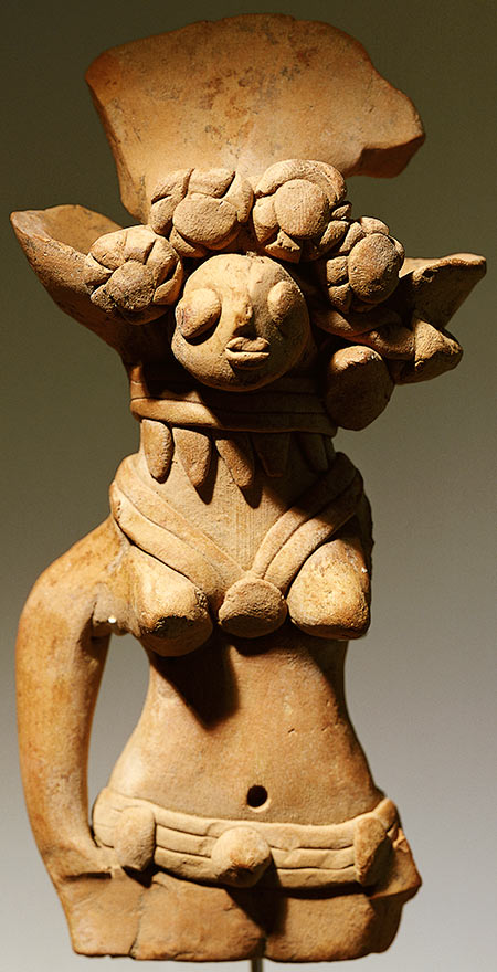 Terracotta figure with a headdress of flowers, rings and a belt, c.3000 BC.