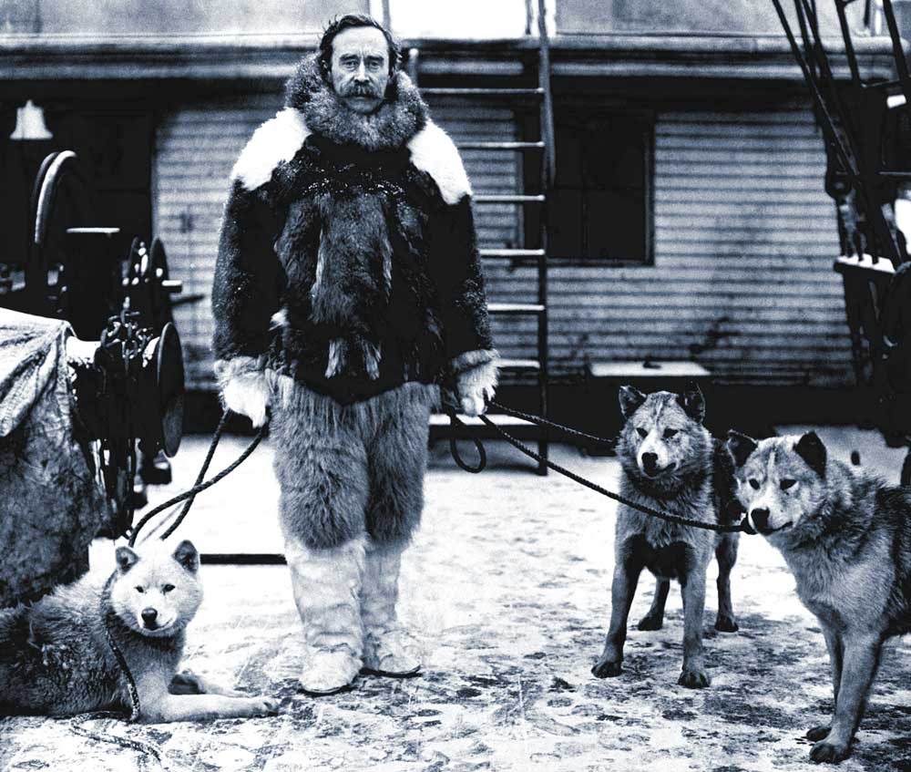 Explorer Robert E. Peary and husky aboard the Roosevelt, c.1909.