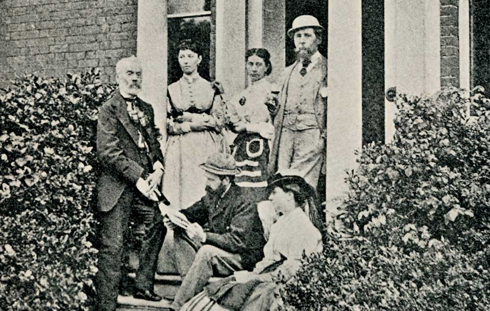 Charles Dickens with family and friends on the porch of Gad’s Hill. Georgina Hogarth is on the bottom right, c.1865.