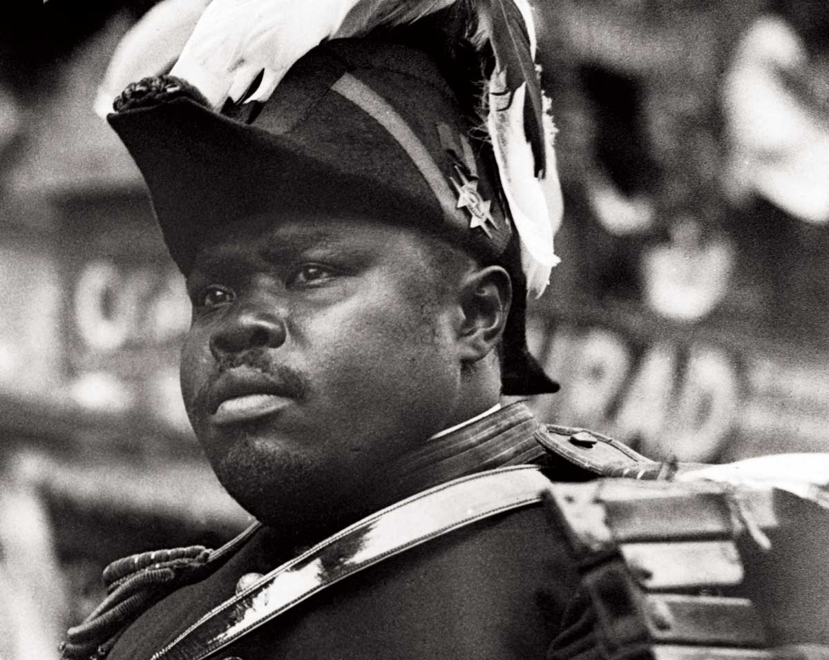 Marcus Garvey riding in a parade. Undated photograph.
