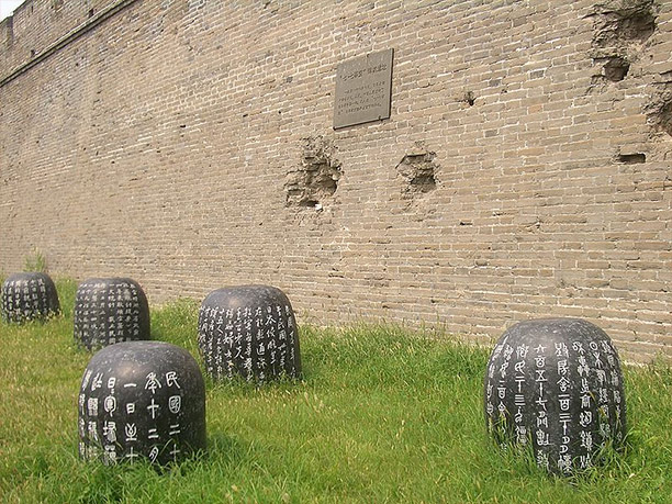 Damage from the Japanese shells on the wall of Wanping Fortress marked with a memorial plaque. Photo / Vmenkov