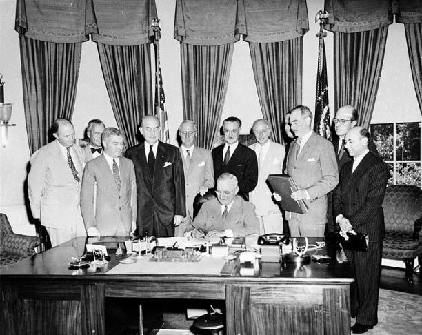 President Truman signs the treaty
