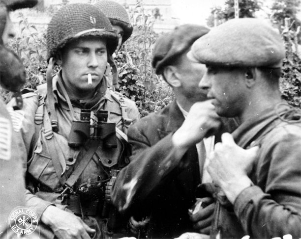  French Resistance members and Allied paratroopers discuss the situation during the Battle of Normandy in 1944