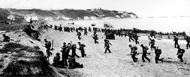  Allied troops hit the beaches near Algiers, behind a large American flag (left).