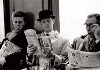 A commuter reads Lady Chatterley’s Lover over their neighbour’s shoulder, London Underground, 1960.
