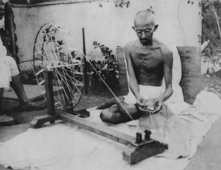 Mahatma Gandhi spinning yarn, in the late 1920s