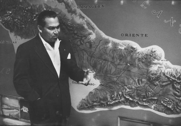 Batista next to a map of the Sierra Maestra mountains, March 1957.