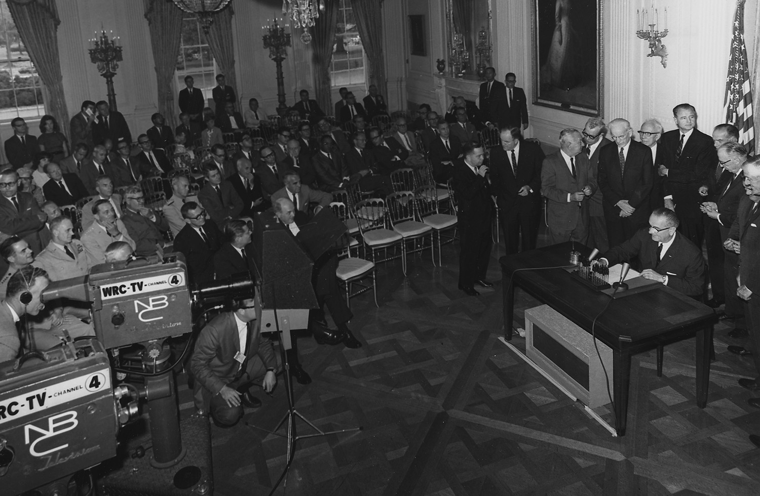 President Lyndon B. Johnson signs the Gulf of Tonkin Resolution, 10 August 1964.