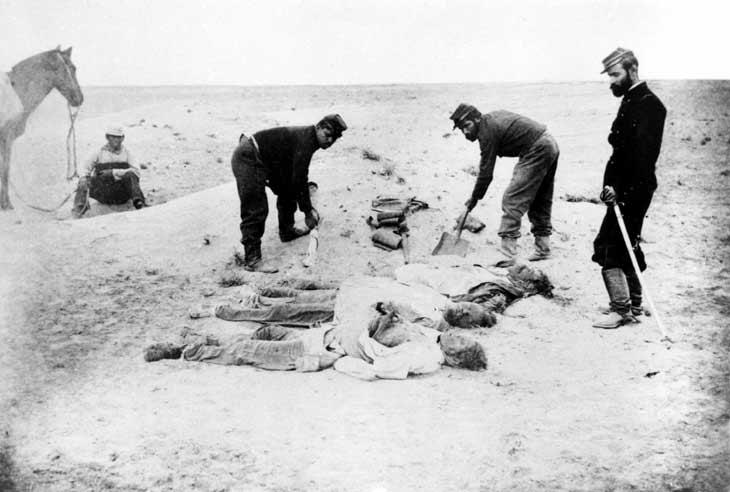 Dead soldiers are buried after the Battle of Tacna, 1880.