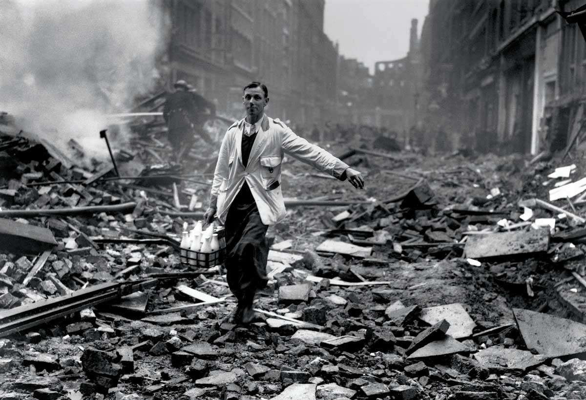 Staged photograph of a ‘milkman’ in a street devastated by a German bombing raid, Holborn, London, 10 September 1940 © Getty Images.