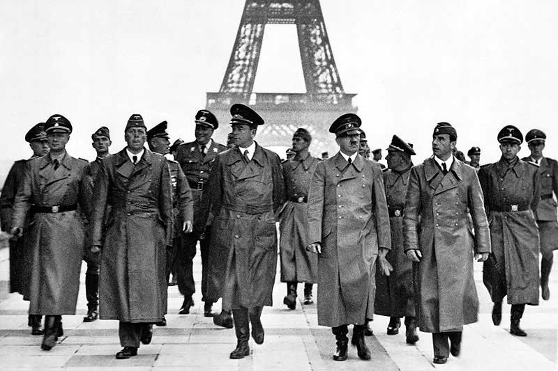 Adolf Hitler visiting the Eiffel Tower on June 23, 1940, following the occupation of France by the Nazis. German Federal Archives/Wiki Commons.
