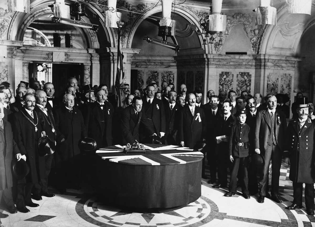 Members of the Ulster Unionist party sign a covenant on ‘Ulster Day’ as part of  their campaign to halt the passage of the Third Home Rule Bill, 28 September 1912 © Hulton Getty Images.