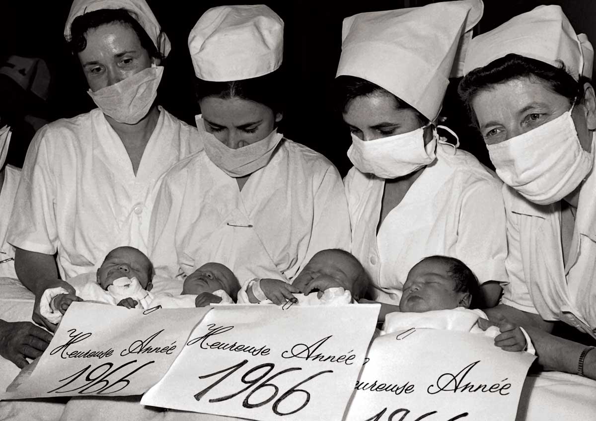 Nurses at the Baudelocque Maternity Hospital in Paris presenting babies born on New Year’s Eve, 1965 © AFP/Getty Images.