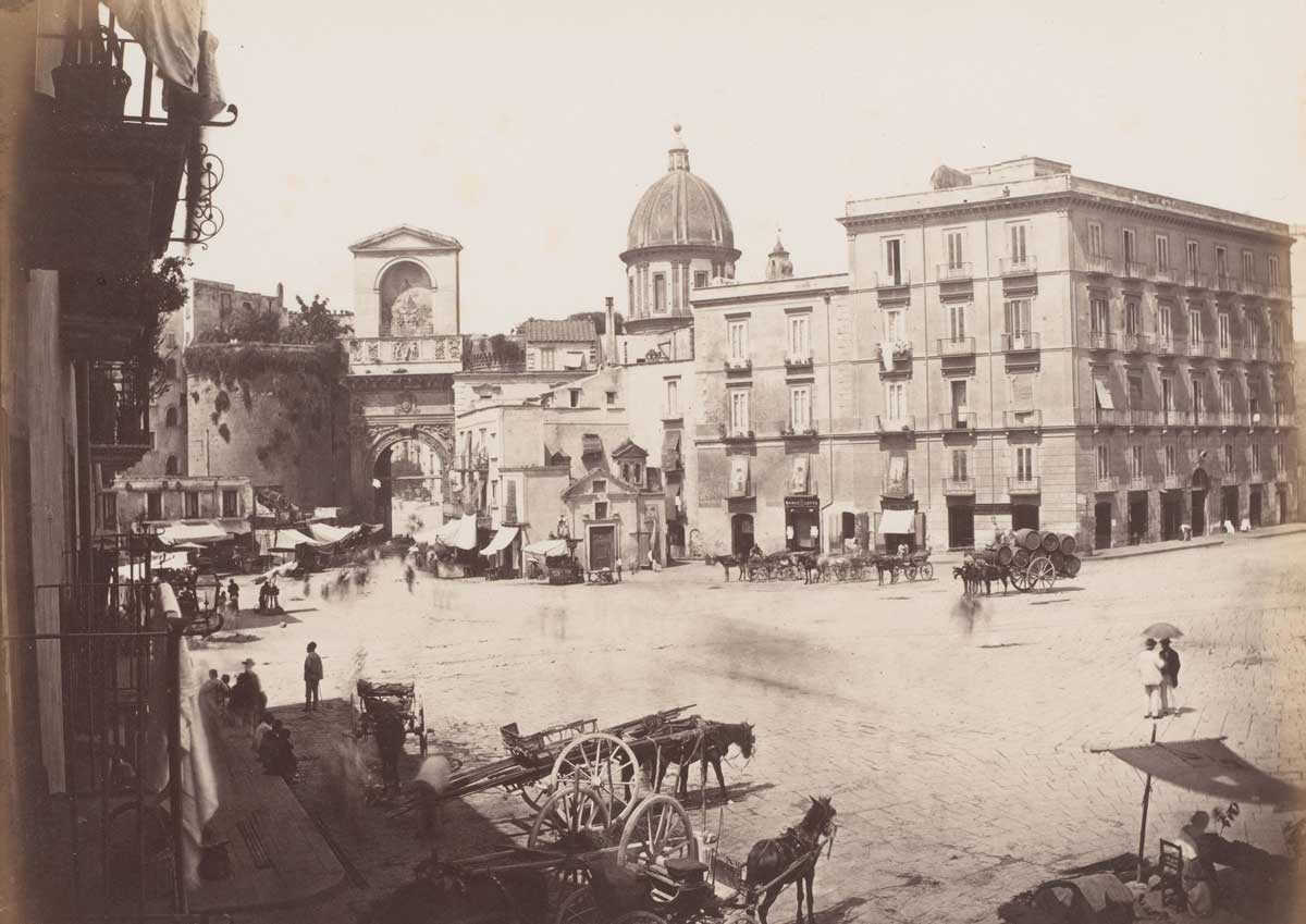 View of a square with the Porta Capuana in the background and the dome of the Santa Caterina a Formiello in Naples, Italy. Photographed by Giorgio Sommer between 1857 and 1914. Rijksmuseum.
