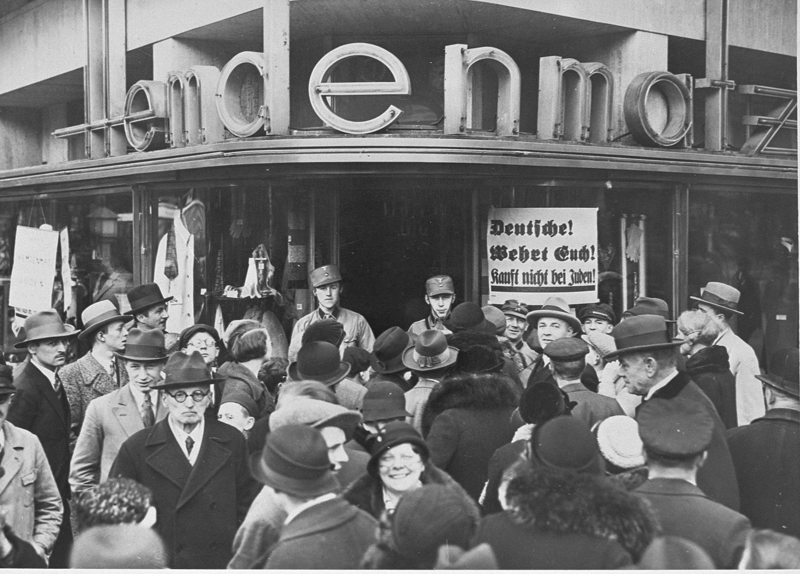 A crowd of Germans outside of a Jewish-owned department store in Berlin on the first day of the Nazi boycott of Jewish-owned businesses, 1 April 1933. United States Holocaust Memorial Museum, courtesy of National Archives. Public Domain.