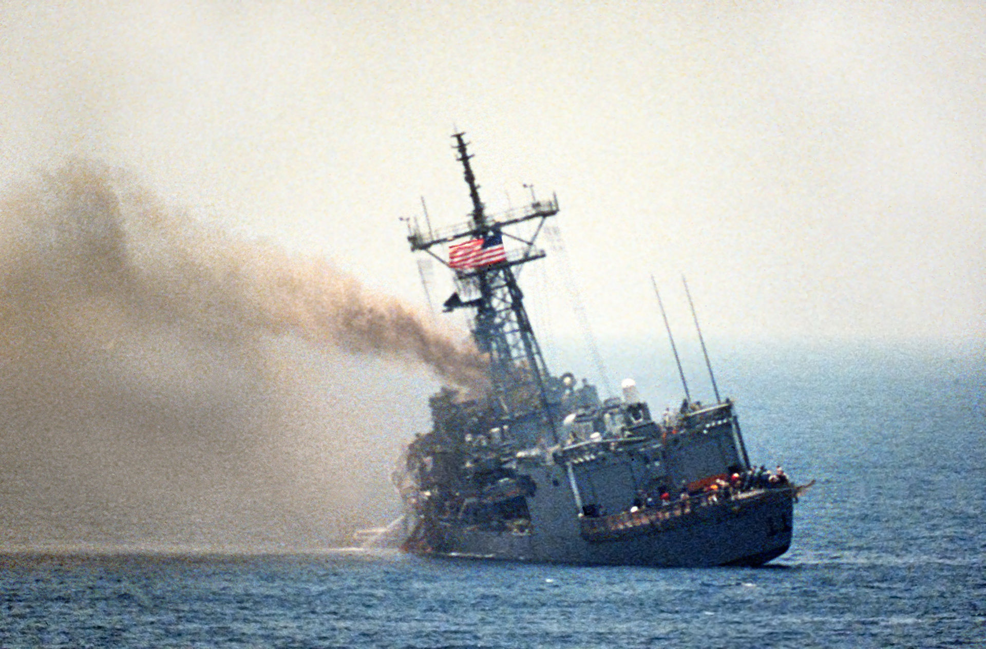 USS Stark lists to port after being struck by an Iraqi-launched Exocet missile in the Arabian Gulf, 17 May 1987. Department of Defense. Public Domain.