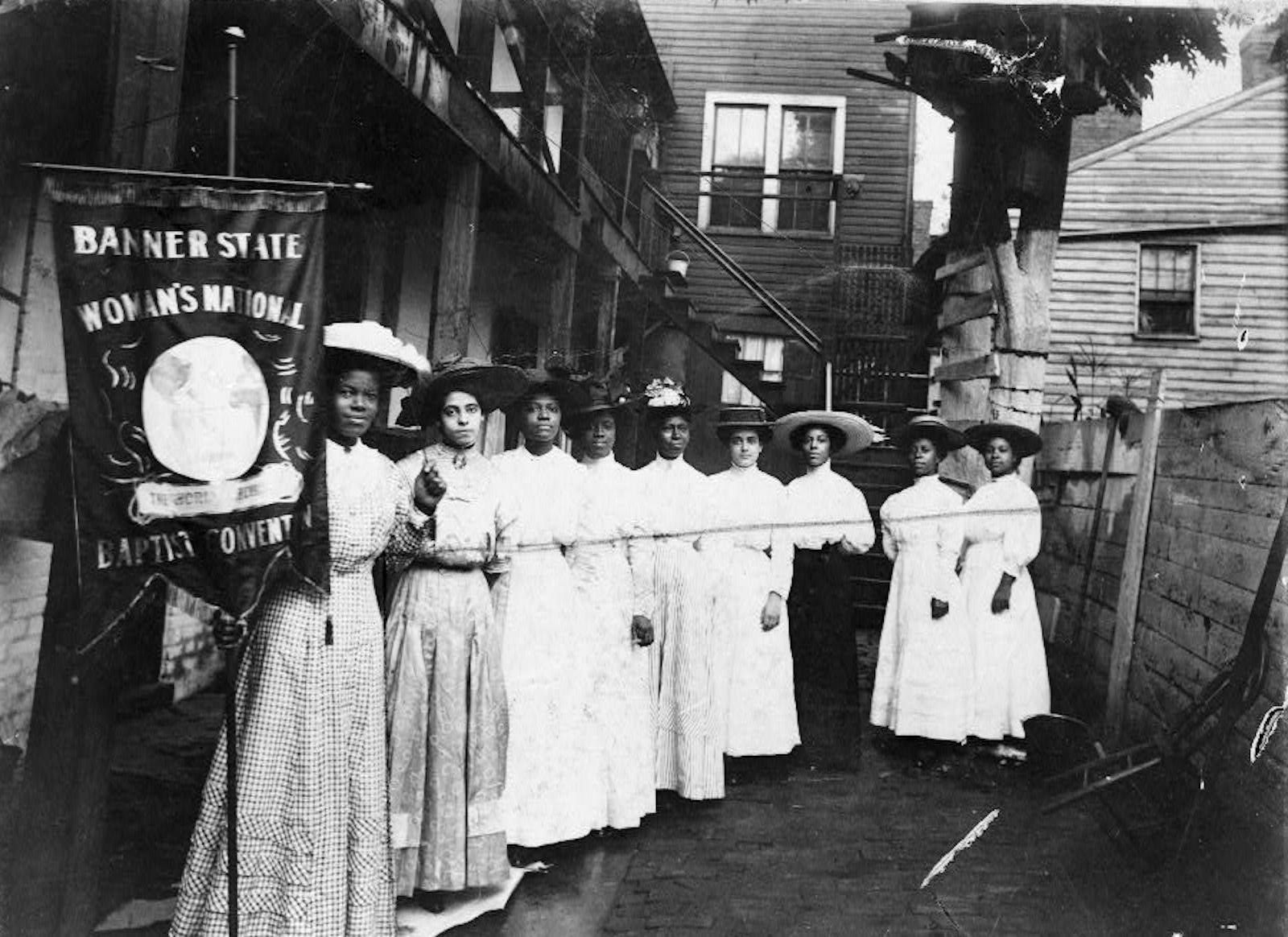 African-American suffragist Nannie Helen Burroughs, far left, at the Banner State Woman’s National Baptist Convention in 1915. Library of Congress. Public Domain.