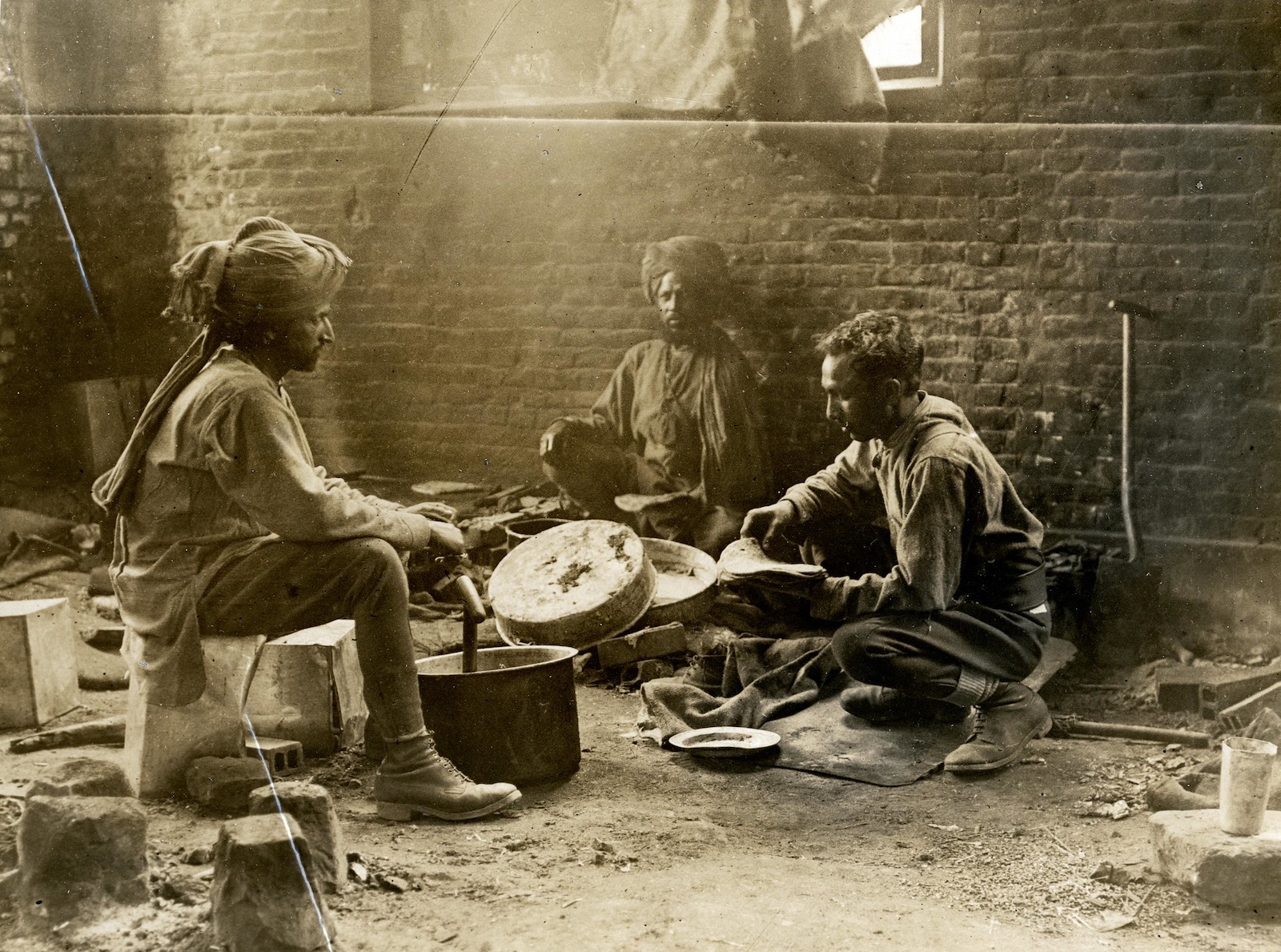 Indian cavalry troopers preparing a meal in Estrée Blanche, France, 25 July 1915. British Library. Public Domain.