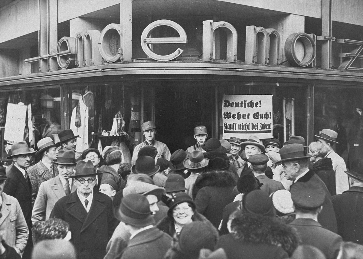 A crowd of Germans outside of a Jewish-owned department store in Berlin on the first day of the Nazi boycott of Jewish-owned businesses, 1 April 1933. United States Holocaust Memorial Museum, courtesy of National Archives. Public Domain.
