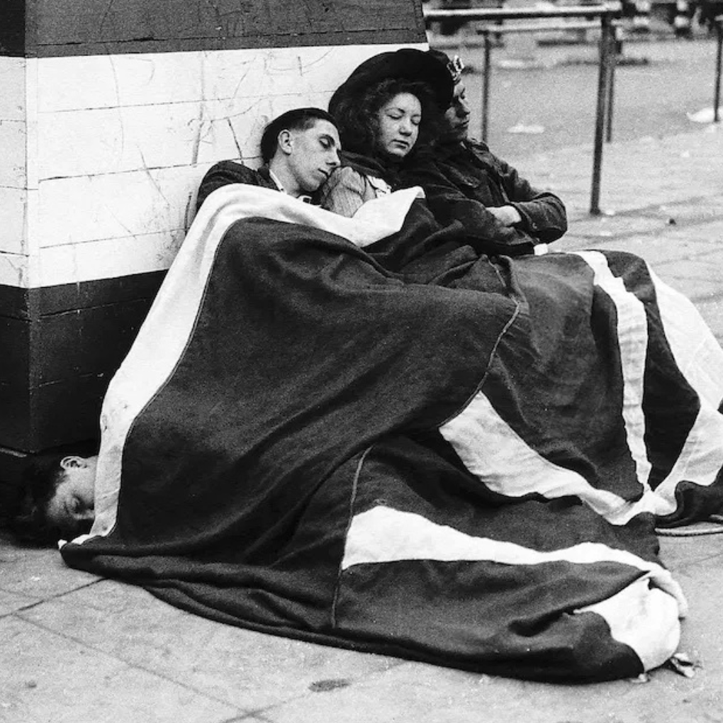 Londoners sleep through the early hours of the morning after a night of celebrations, 8 May 1945. Mirrorpix.
