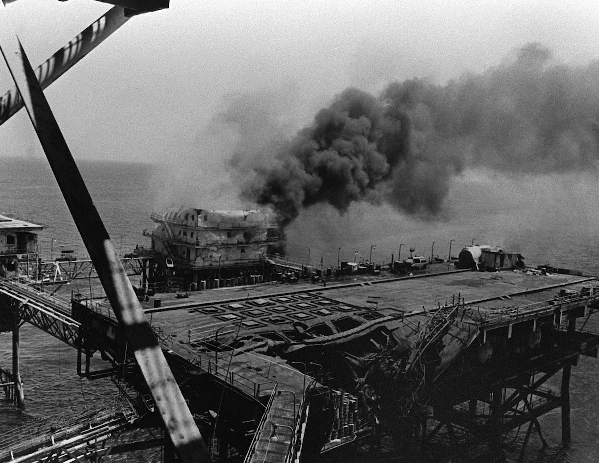 An Iranian oil platform burns after being hit by the US Navy in retaliation for the mining of USS Samuel B. Roberts, 18 April 1988. National Archives and Records Administration. Public Domain. An Iranian oil platform burns after being hit by the US Navy in retaliation for the mining of USS Samuel B. Roberts, 18 April 1988. National Archives and Records Administration. Public Domain.