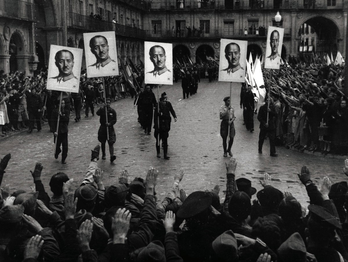 A parade in Salamanca celebrates the occupation of Gijón by Francoist troops, September 1937. Geopix/Alamy Stock Photo. A parade in Salamanca celebrates the occupation of Gijón by Francoist troops, September 1937. Geopix/Alamy Stock Photo.
