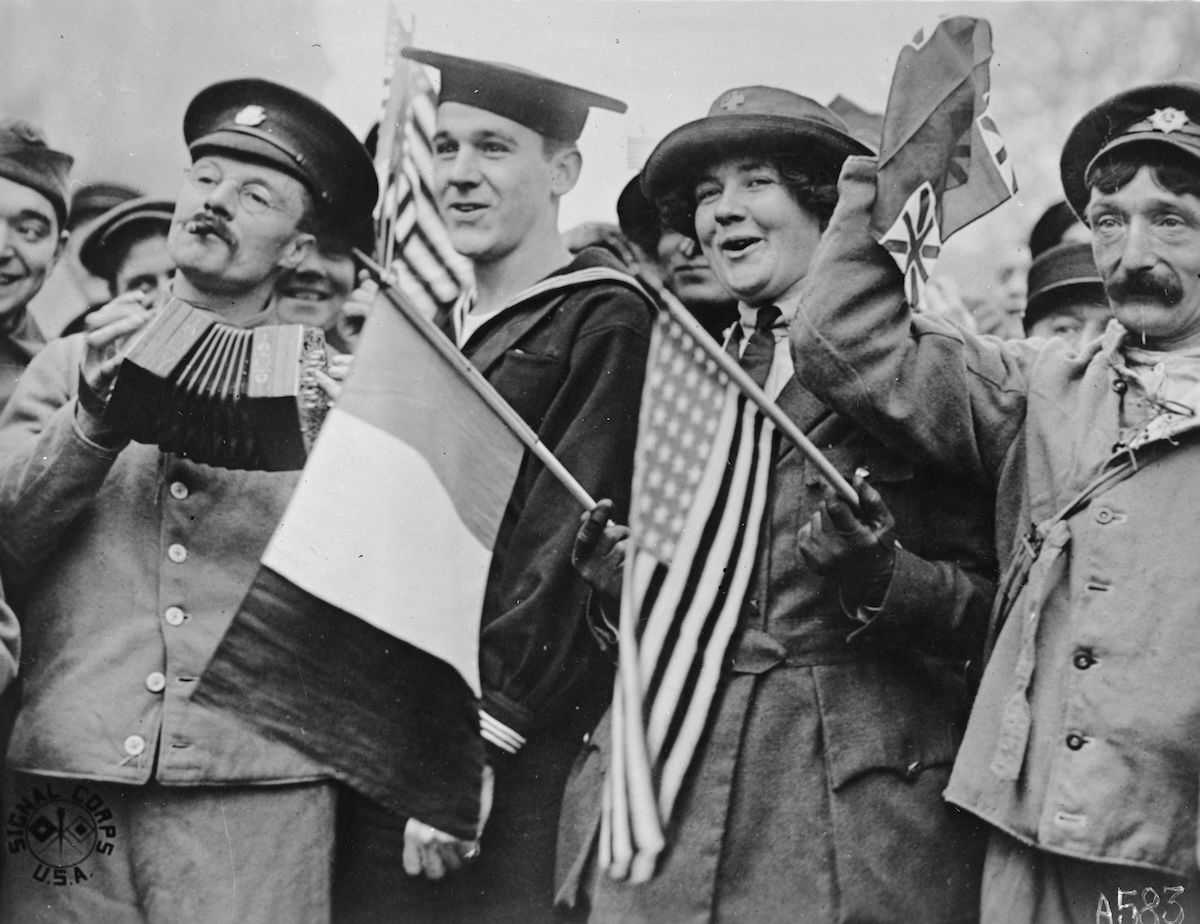 Two wounded British soldiers, a sailor, and an American Red Cross volunteer celebrate the Armistice in Paris, 11 November 1918. Library of Congress.