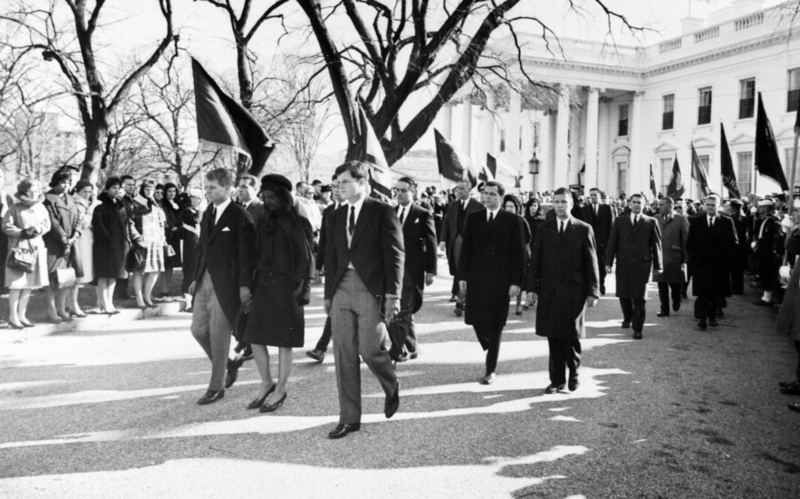 Jacqueline Kennedy, accompanied by her brothers-in-law, Attorney General Robert F. Kennedy and Senator Edward Kennedy, walking from the White House as part of the funeral procession accompanying President Kennedy's casket to St. Matthew's Cathedral.