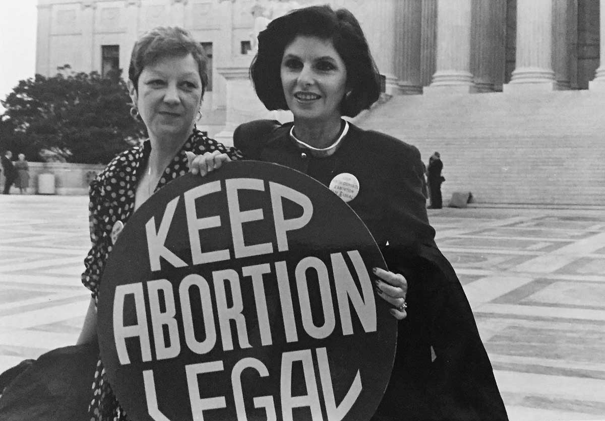 Norma McCorvey (Jane Roe) and her lawyer Gloria Allred on the steps of the Supreme Court, 1989. Wiki Commons.