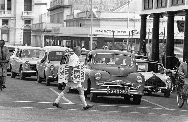 A supporter of the Smith government delivers election campaign posters, 1964. Express / Getty Images