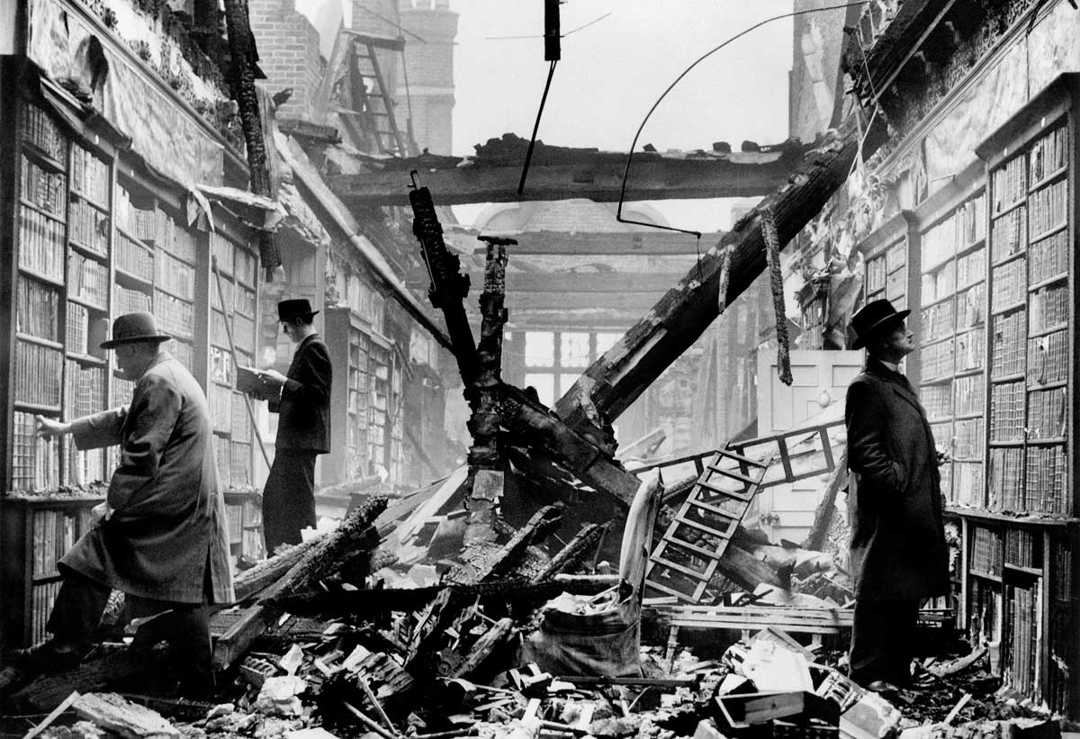 Holland House library after an air raid, 23 October 1940. This photograph was likely staged for propaganda purposes. Wiki Commons.