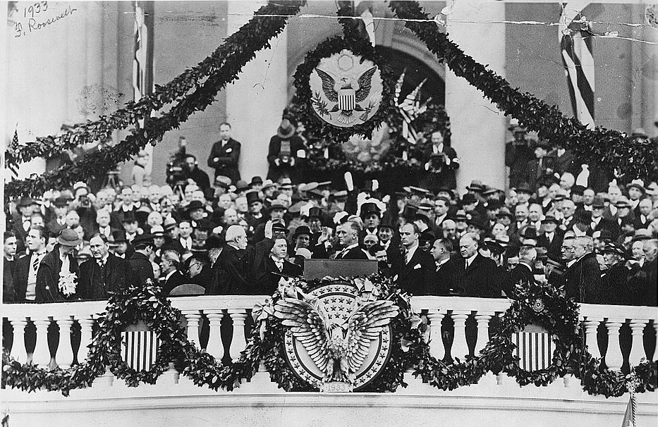 Chief Justice Charles Evans Hughes administering the oath of office to Franklin Delano Roosevelt on the east portico of the U.S. Capitol, March 4, 1933 Library of Congress.
