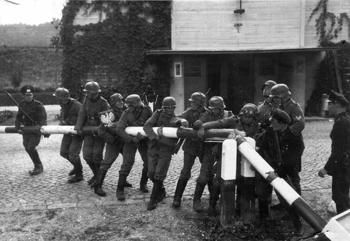 Soldiers of the German Wehrmacht tearing down the border crossing into Poland, 1 September 1939