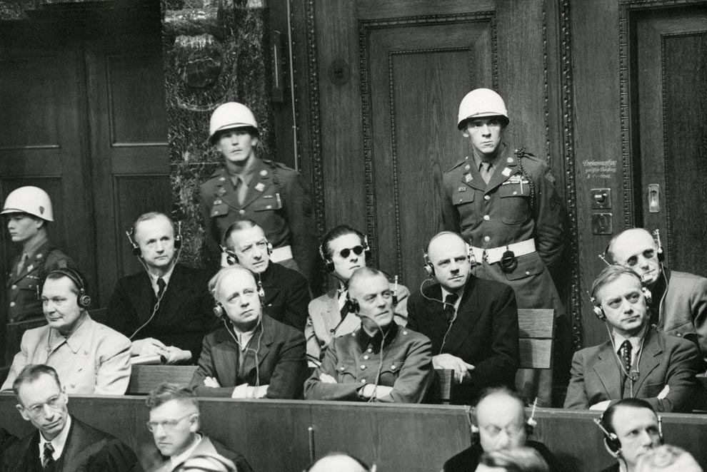 Nuremberg Trials defendants photographed in the dock, 22 November 1945. Joachim von Ribbentrop seated front row, second from left. 